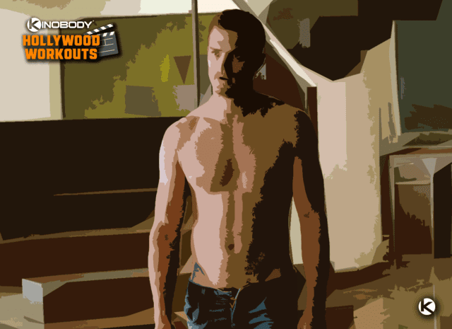 A shirtless man standing in a room.